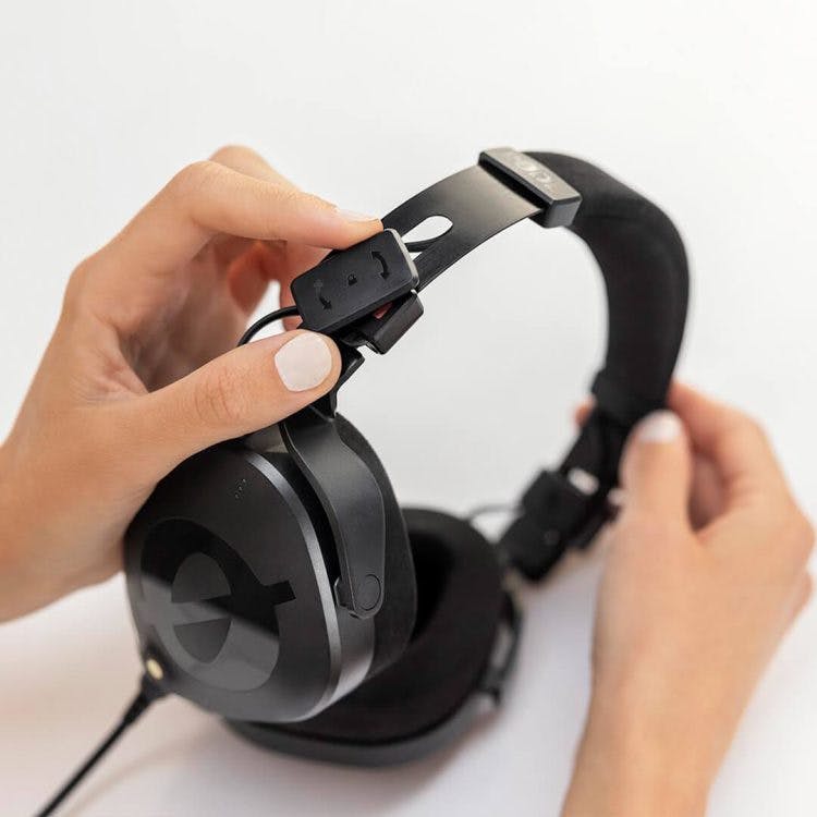 Rode NTH-100 headphones FitLok system being adjusted showing plastic mechanism and steel headband